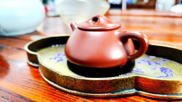 ceramic teapot and cup of tea on the table