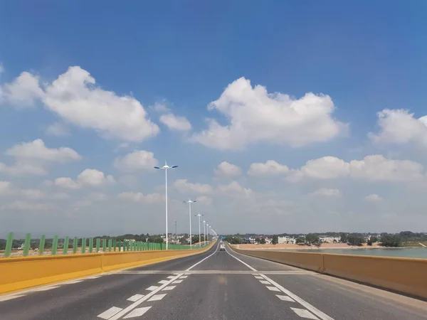 highway road with blue sky and white clouds