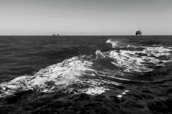 black and white photo of a sea waves on the coast of the mediterranean ocean