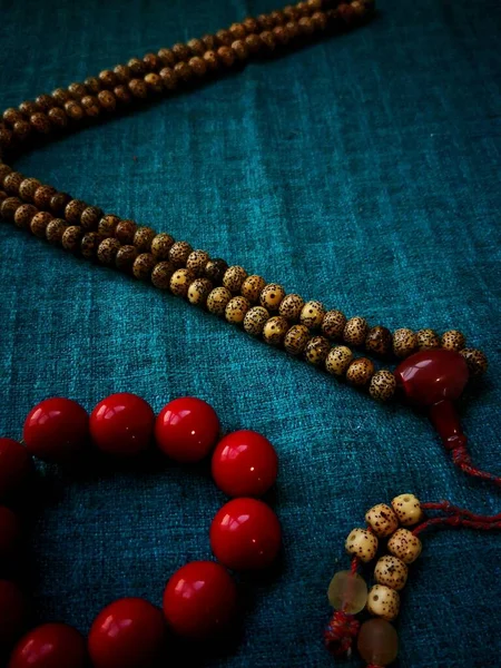 rosary beads on wooden background