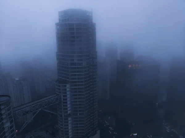 modern city buildings in the fog