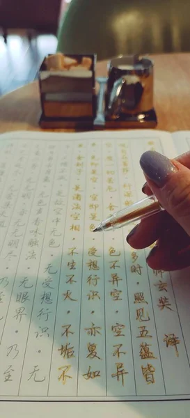 stock image woman writing on a notebook with a pen