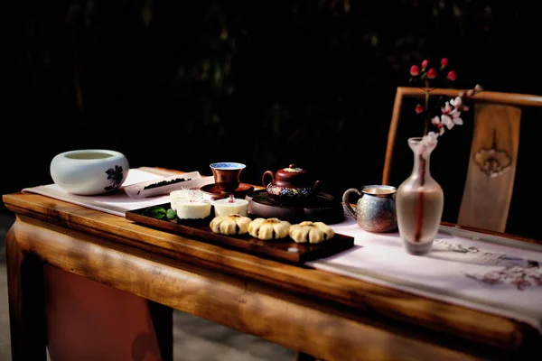 breakfast with a cup of tea and a teapot on a wooden table