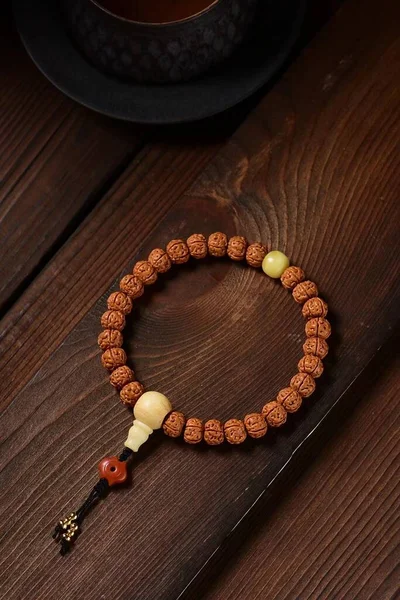 rosary beads on wooden background