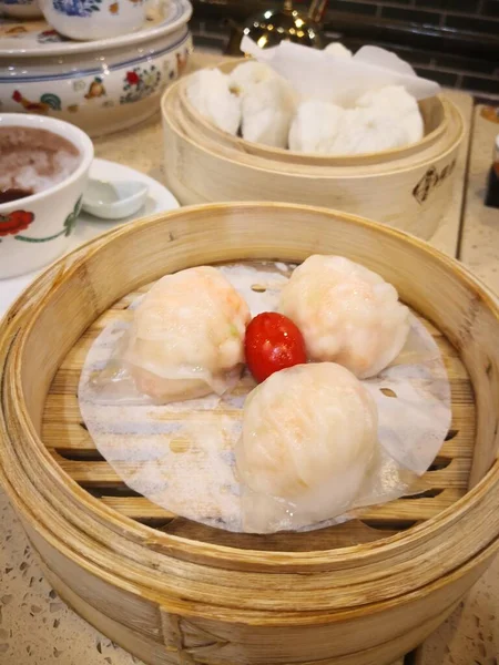 chinese steamed dumpling with sauce and vegetables