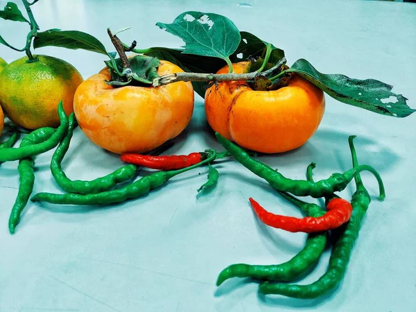 green and red peppers on a white background