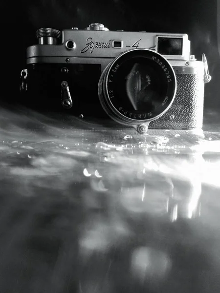 old camera on the background of a black and white photo