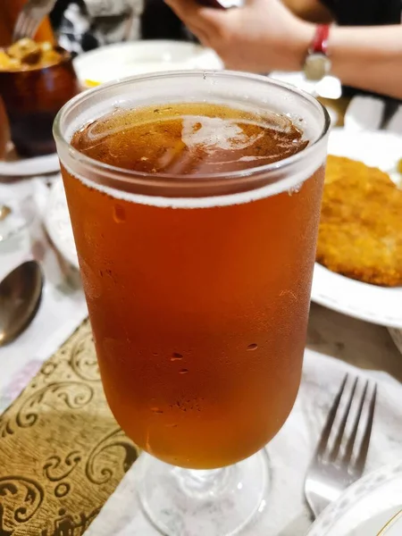 a cup of coffee with a glass of beer and a mug of tea