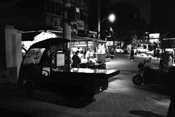 black and white photo of a street in the city