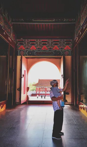 stock image asian man in traditional clothes with backpack walking in the city