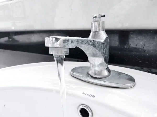 close up of a white sink with a water tap