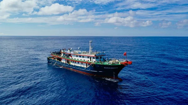 a view of the sea with a ship in the background