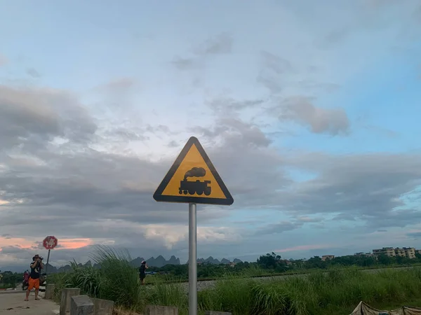 road sign with a warning symbol