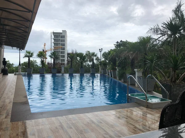 swimming pool with green grass and blue sky