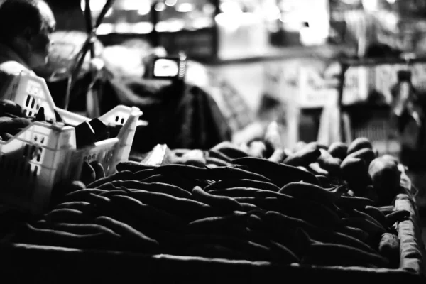 black and white photo of a man in a shop