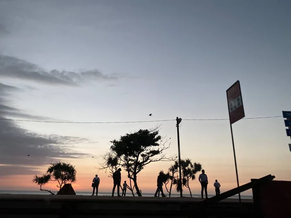 silhouette of a man and woman on the beach