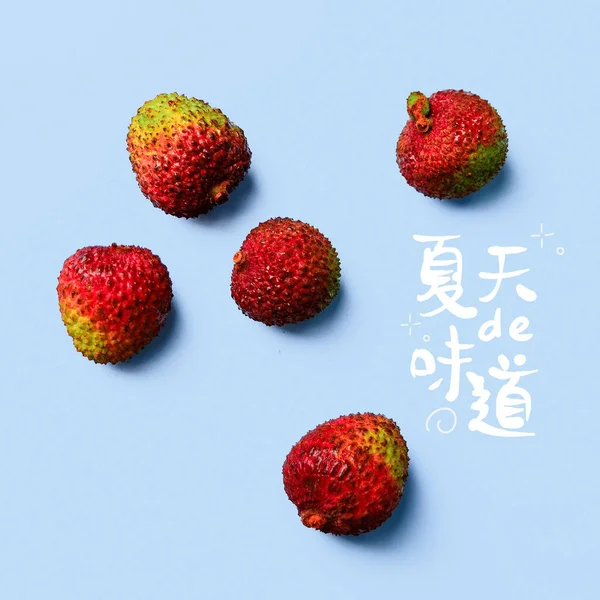 red and white strawberries on a blue background.