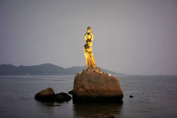 statue of a man in the sea