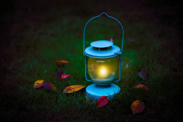 lantern with potion and candle in the dark forest