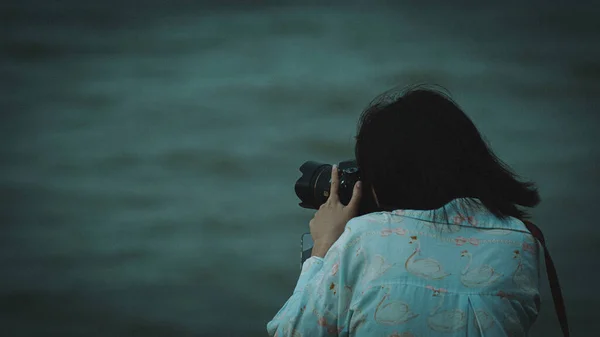 girl photographer with camera in the forest