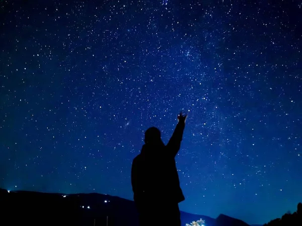 silhouette of a man with a star against a background of stars