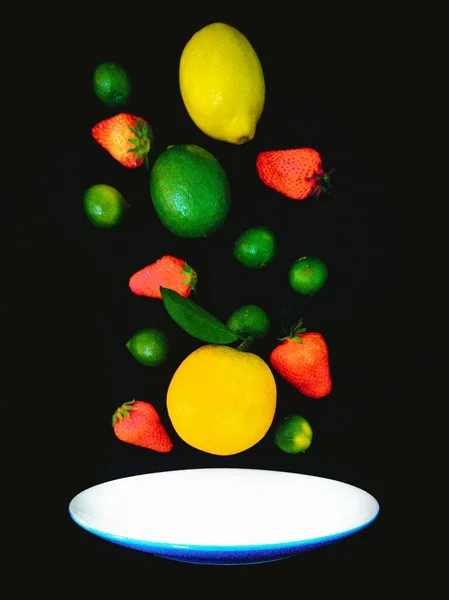 colorful fruits and vegetables on a black background
