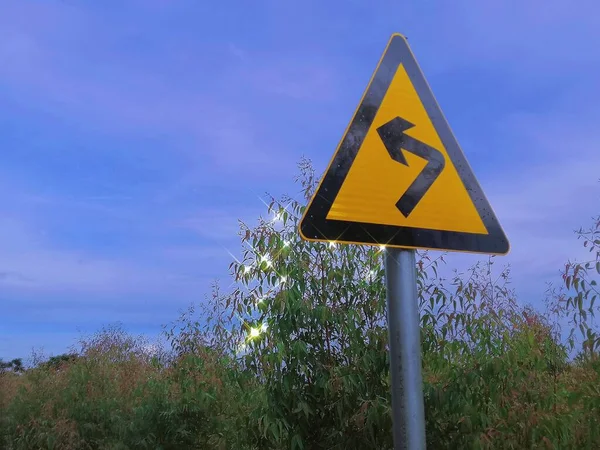 road sign with a warning symbol