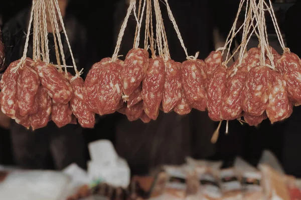 raw meat sausages on a market stall