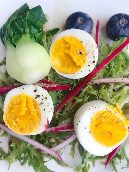 fresh salad with eggs, egg and cheese