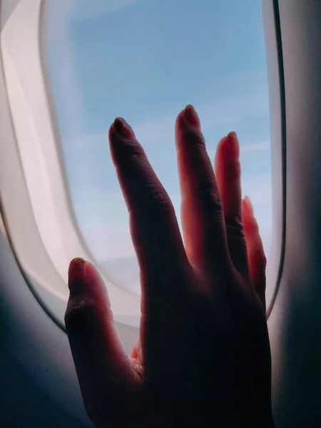 woman hand with a window in the sky