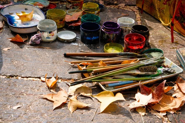 autumn still life with paints and brushes