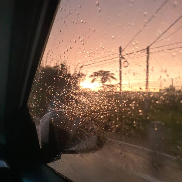 the sun shines through the window of the car