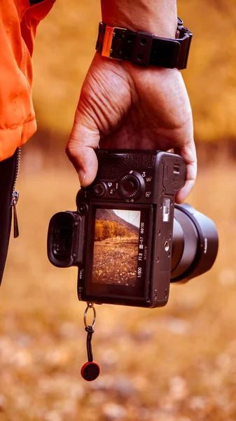 man with camera in the forest