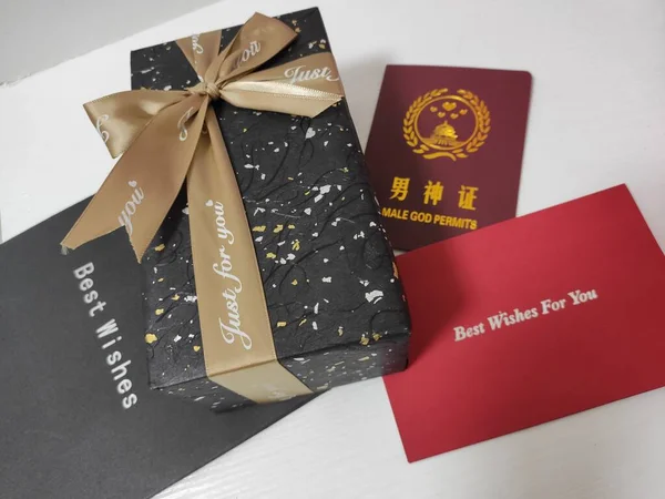 close-up of a book with a gift and a red ribbon on a white background