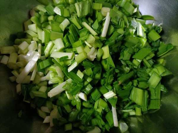 chopped green onions in a pan