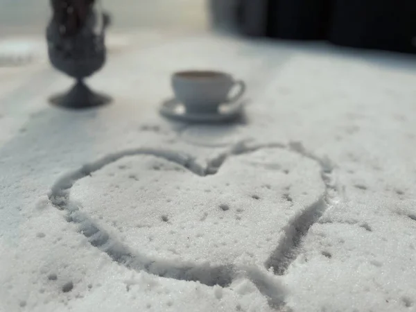 heart shaped coffee cup on the snow