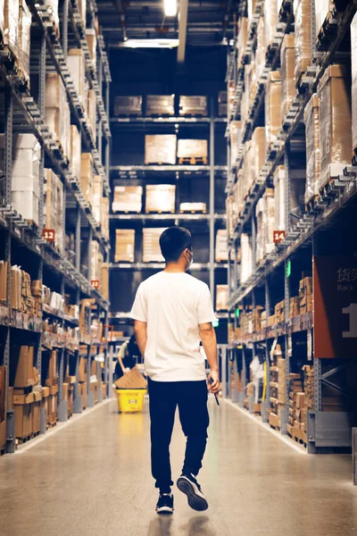 warehouse worker with boxes in supermarket