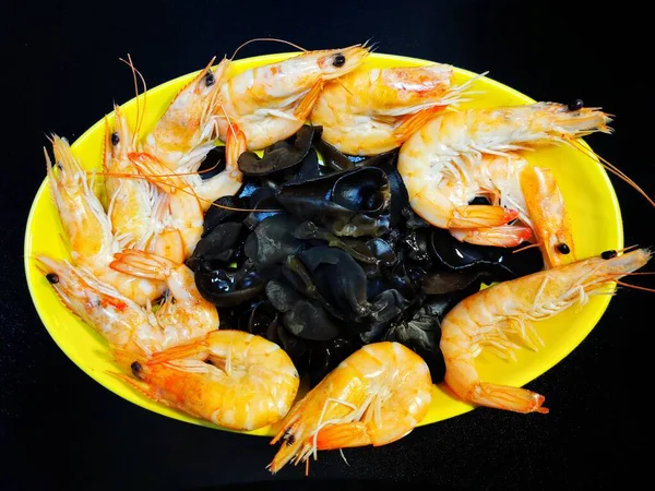 grilled shrimps on black background