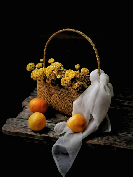 basket with fruits and vegetables on black background