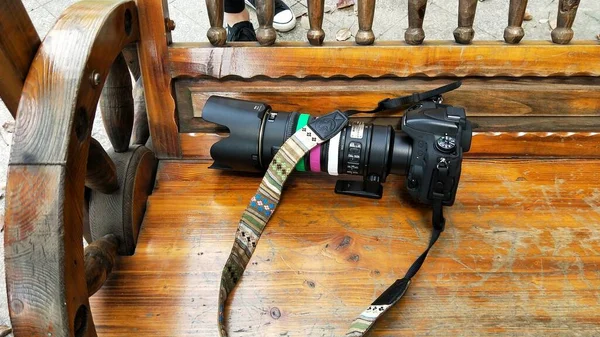 old camera with a wooden handle on a wood background