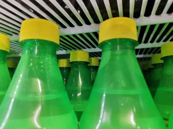 green and yellow plastic bottles on the table