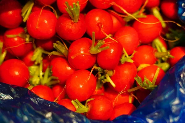 fresh red and green tomatoes on a market stall