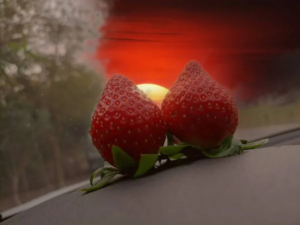 red and white strawberries on a wooden background