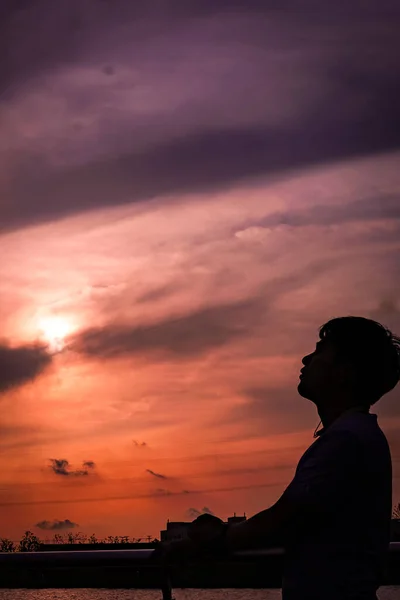 silhouette of a man with a backpack on the beach