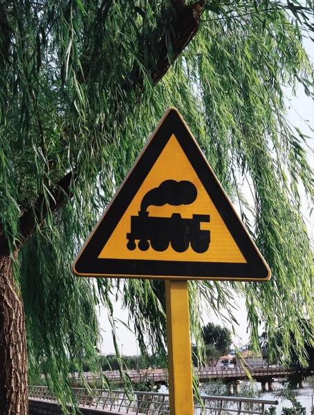 road sign with a warning symbol