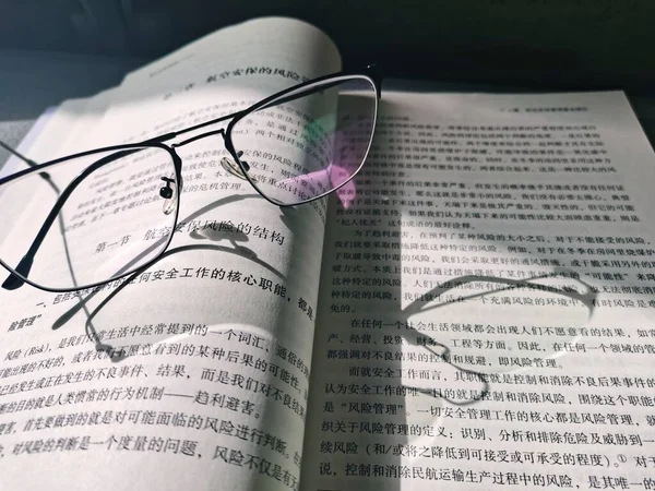 close up of a book with glasses and eyeglasses