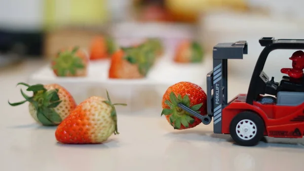 red and white mini food box with fresh ripe strawberries