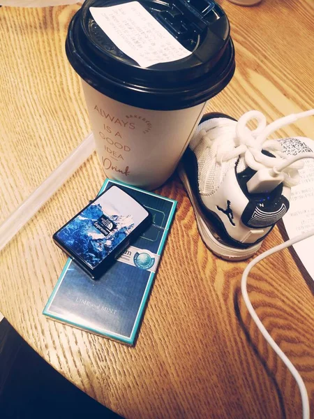 cup of coffee and a smartphone on the table