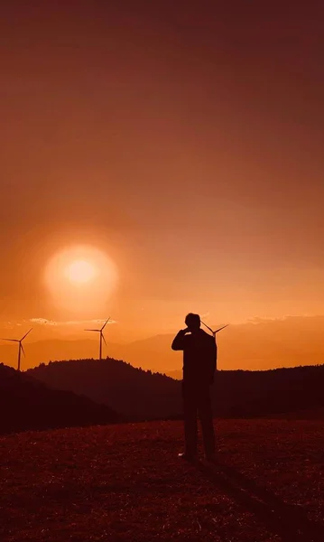 silhouette of a man with a sword on the background of the sunset