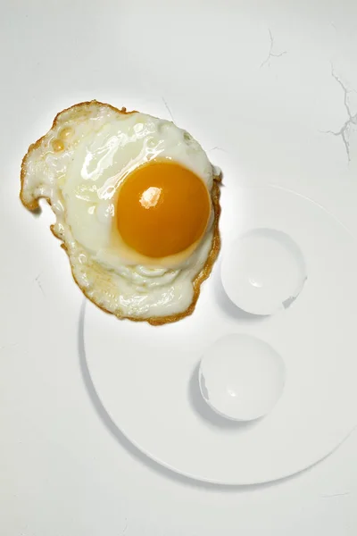 egg with yolk and eggs on white background